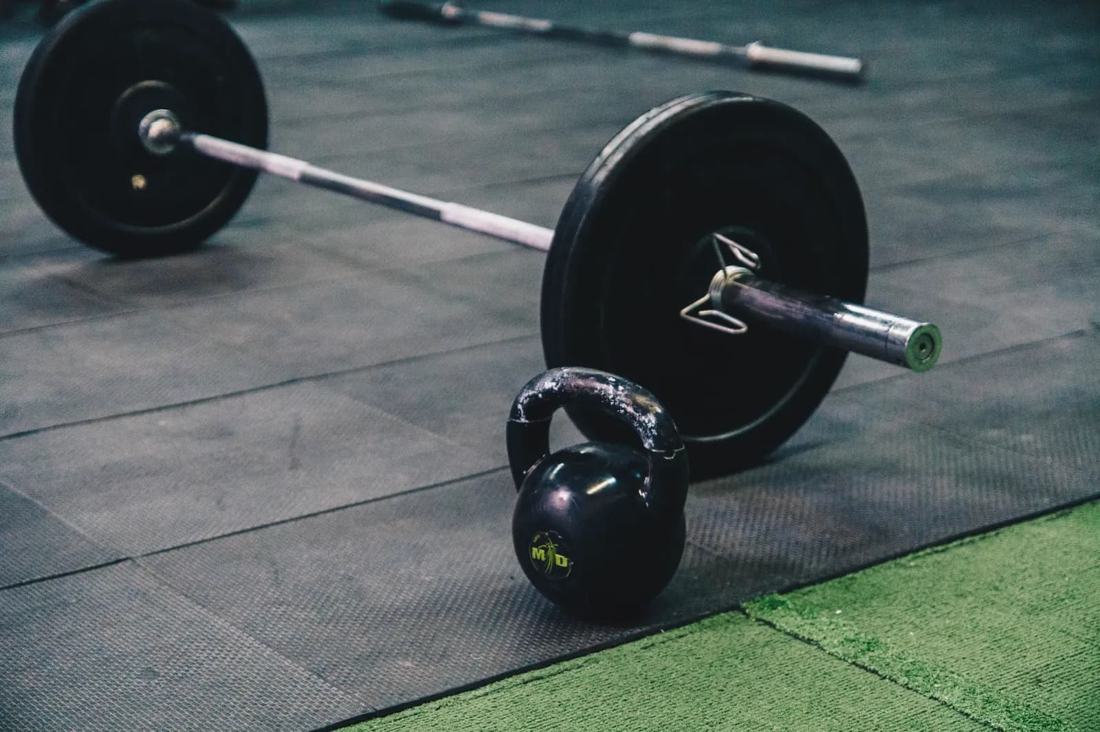 Gym floor — racks and free weights in use.